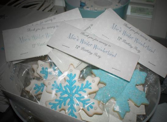 Frozen inspired cookies, expertly decorated sugar cookies in blue and white frosting, with a thank you for coming! 